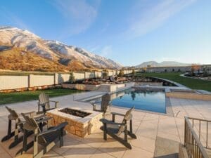 Mountain view backyard with pool and chairs.